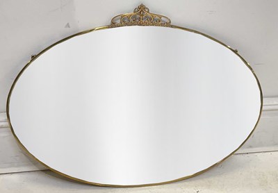 Lot 36 - An Art Nouveau brass framed oval wall mirror...