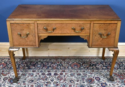 Lot 2847 - A 1920's walnut desk, with three drawers, on...