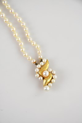 Lot 2153 - A yellow metal pearl two row necklace, with...