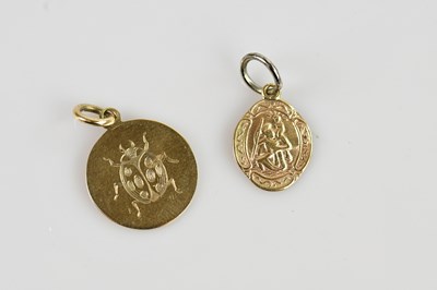 Lot 2154 - Two 9ct yellow gold pendants, one example...