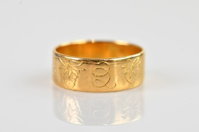 Lot 2504 - A 22ct yellow gold wedding band, with engraved...