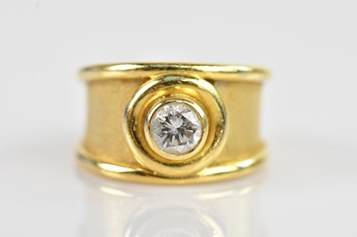 Lot 2269 - A yellow metal diamond set broad ring,...