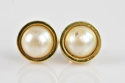 Lot 1438 - A pair of yellow metal and pearl set ear studs,...