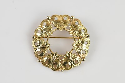 Lot 1303 - A 9ct yellow gold circular brooch with...