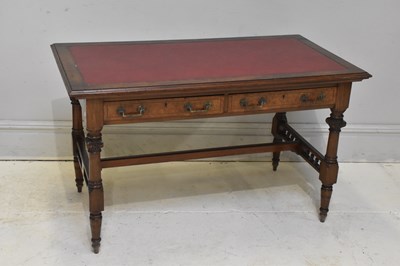 Lot 221 - A Victorian walnut writing table, with red...