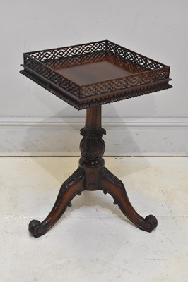Lot 128 - A reproduction carved hardwood tripod table,...