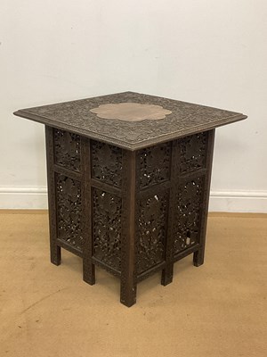 Lot 765 - An Anglo Indian carved hardwood folding table,...
