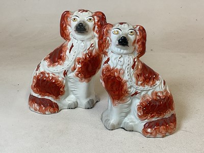 Lot 402 - A pair of Staffordshire spaniels, height 25cm.