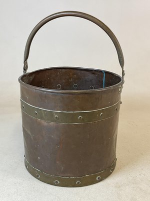 Lot 381 - A copper bucket with brass handle and riveted...
