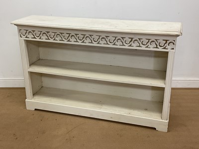 Lot 829 - A painted wooden low open bookcase with carved...