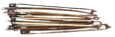 Lot 410 - Five three-quarter size violin bows, four...