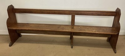 Lot 752 - A stained pine church pew, with attached fold...