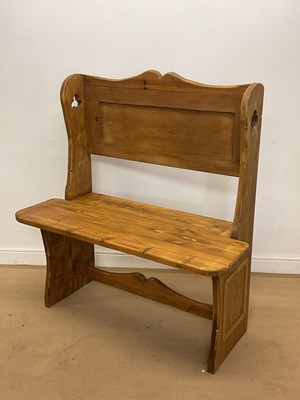 Lot 753 - A pine settle with shaped stretcher and back,...