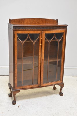 Lot 166 - A reproduction walnut bookcase, height 130cm,...