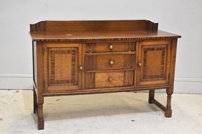 Lot 268 - A 1920s oak sideboard with three drawers and...