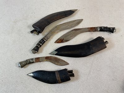 Lot 348 - Three Gurkha kukris all with sheaths and small...