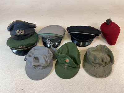 Lot 280 - A selection of foreign forces headwear, to...