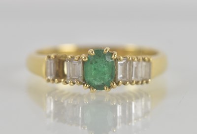 Lot 1306 - A yellow gold emerald and diamond set ring,...