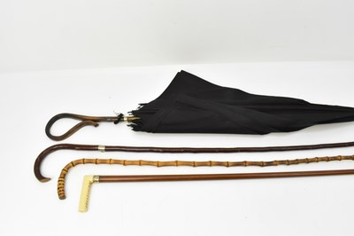 Lot 792 - A vintage cane/bamboo umbrella with black...