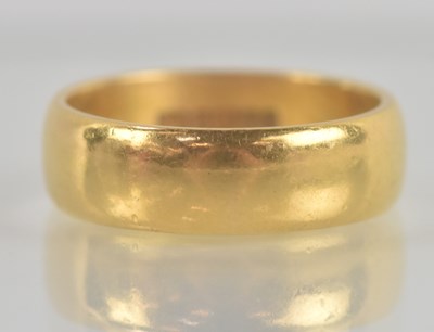 Lot 1298 - A 22ct yellow gold band ring, with plain...