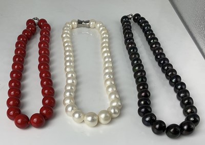 Lot 677 - Three substantial bead necklaces, one with...