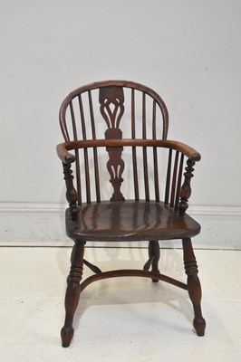 Lot 216 - A 19th century yew wood and elm seated Windsor...