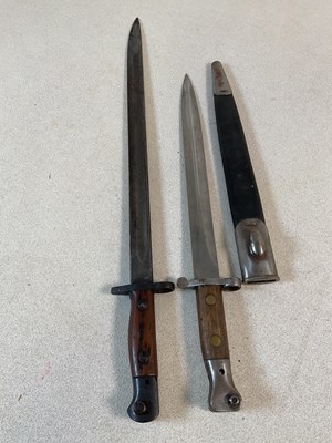 Lot 334 - Two bayonets, one in scabbard, lengths 55.5 cm...