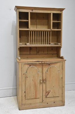 Lot 83 - An old pine dresser with boarded plate rack...