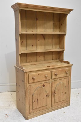 Lot 84 - An old pine dresser with boarded plate rack...