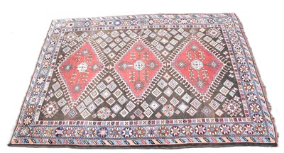 Lot 396 - A brown ground Turkmen wool carpet, with...