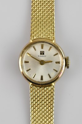 Lot 514 - TISSOT; a lady's yellow metal cased wristwatch,...