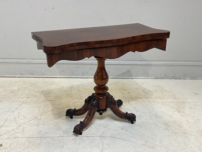 Lot 237 - A 19th century rosewood fold-over tea table,...