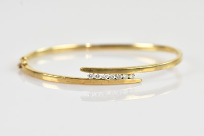 Lot 1131 - A 9ct yellow gold diamond set hinged snap...