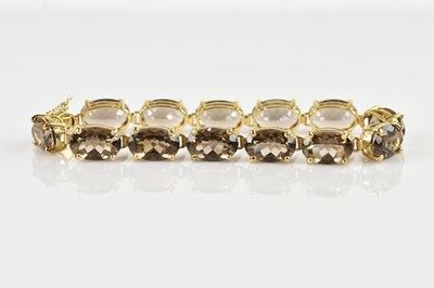 Lot 1204 - A yellow metal bracelet set with thirteen oval...