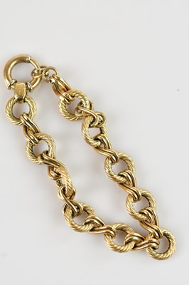 Lot 1142 - A yellow metal circular textured link bracelet,...