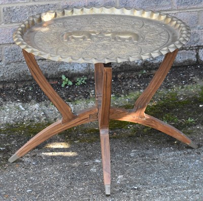 Lot 89 - A brass top folding table