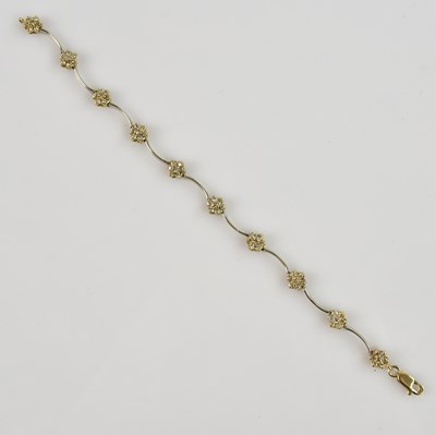 Lot 1184 - A yellow and white metal diamond set bracelet,...