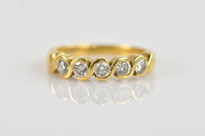 Lot 2334 - An 18ct yellow gold diamond set five stone...