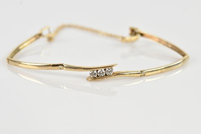 Lot 1181 - A yellow metal diamond set hinged bracelet,...