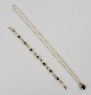 Lot 1221 - A 9ct yellow gold diamond and sapphire set...