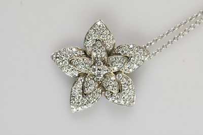 Lot 2159 - A white metal diamond set floral pendant,...