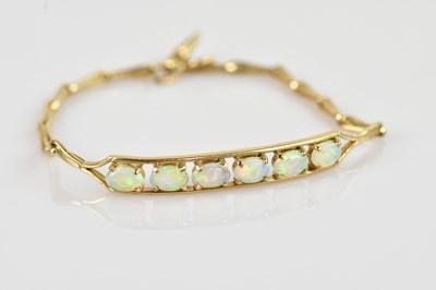 Lot 1232 - A yellow metal opal set bracelet, stamped '9K',...