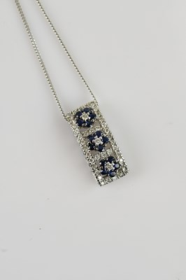 Lot 2095 - A 9ct white gold diamond and sapphire pendant,...