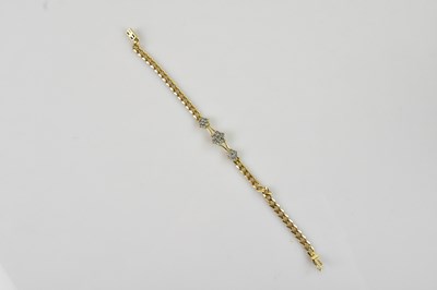 Lot 1199 - A yellow metal diamond set flat link bracelet,...