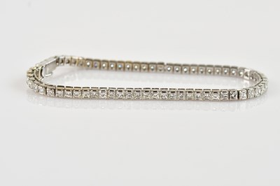 Lot 1108 - An 18ct white gold diamond set tennis bracelet,...