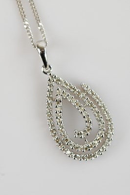 Lot 2136 - A 9ct white gold diamond set pendant, set with...