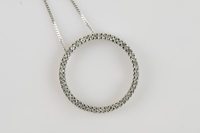 Lot 2085 - A 9ct white gold diamond set circular pendant,...