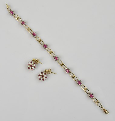 Lot 1244 - A 9ct yellow gold bracelet, set with oval pink...