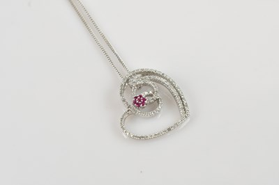 Lot 2084 - A 9ct white gold diamond set pendant formed as...