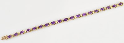 Lot 1243 - A 9ct yellow gold amethyst set bracelet, set...